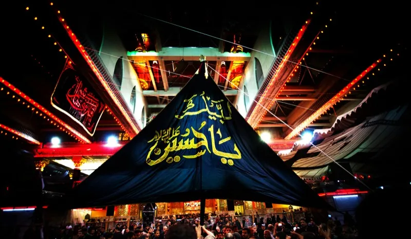 A 'Ya Husayn' canopy lit up during a Muharram majlis