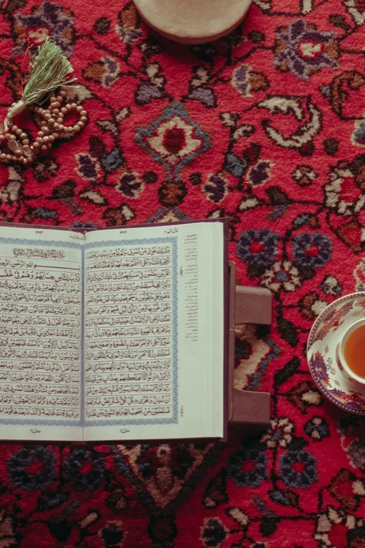 The Qur'an open on a wooden stand