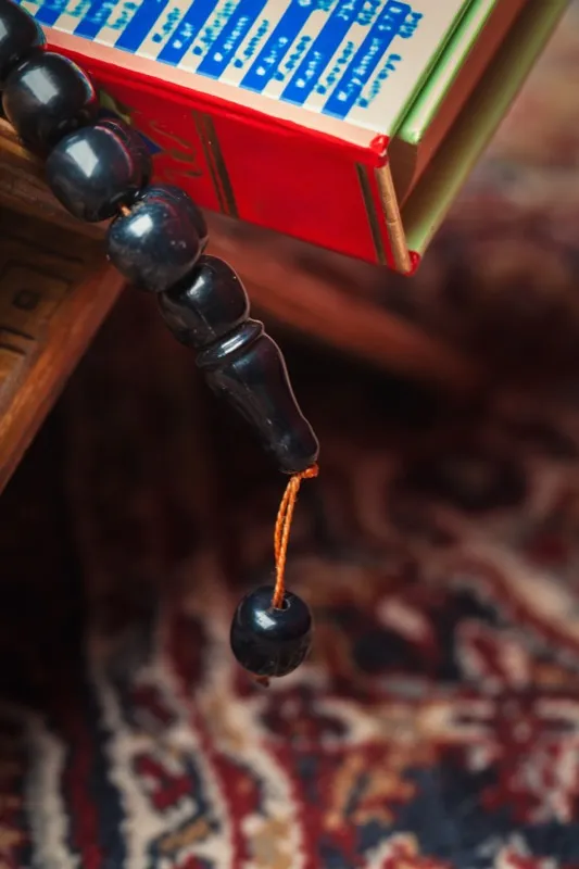 A colorful Qur'an with prayer beads